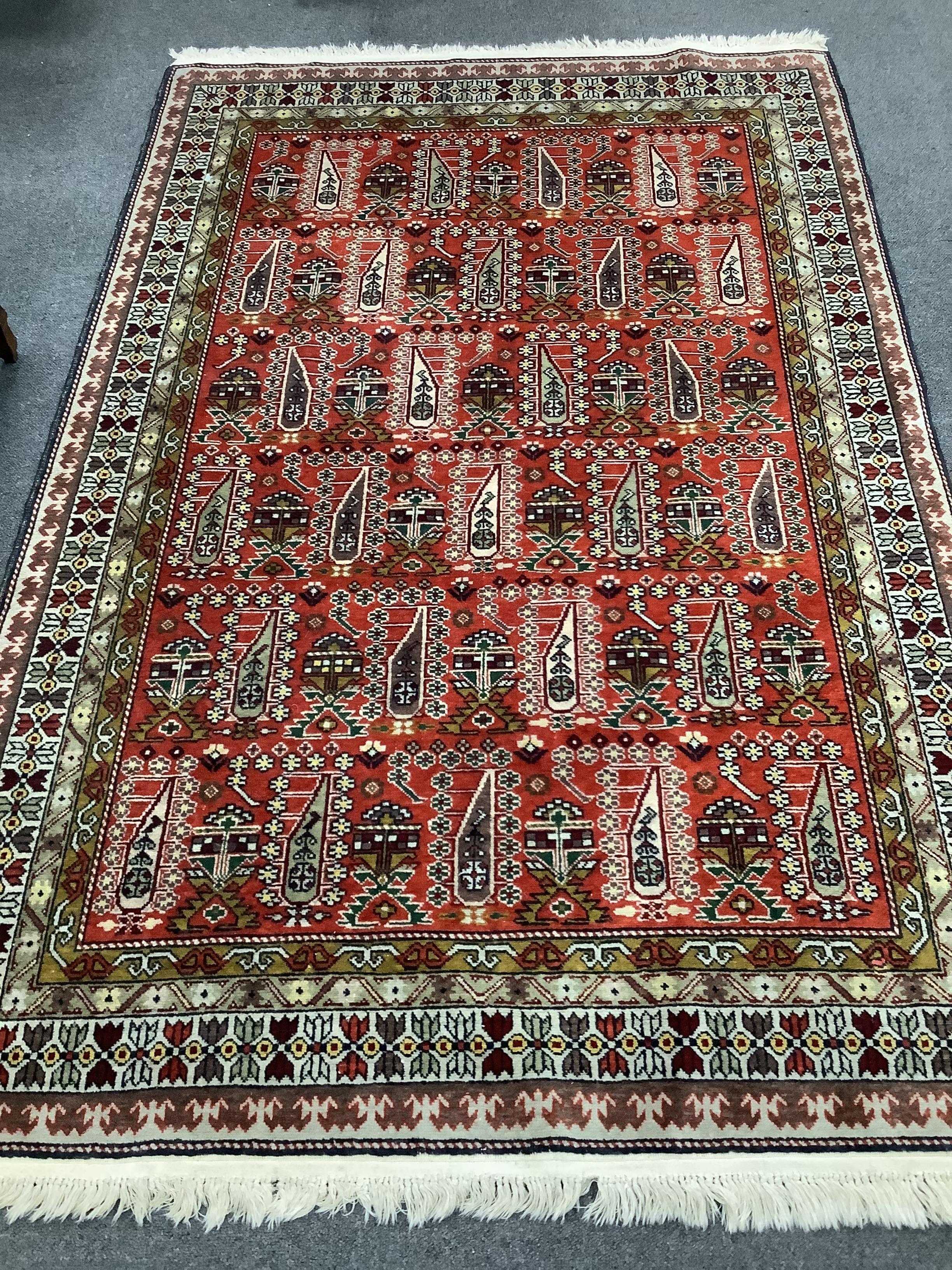 A North West Persian stylised Boteh red ground rug, 180 x 121cm